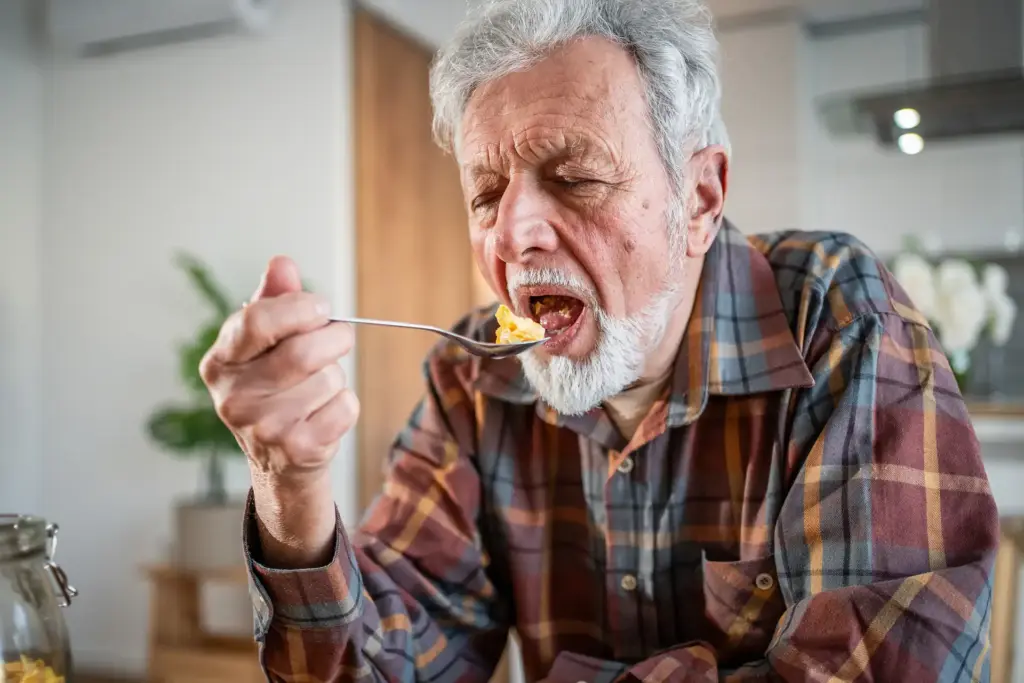 Home gran menjant amb ganes